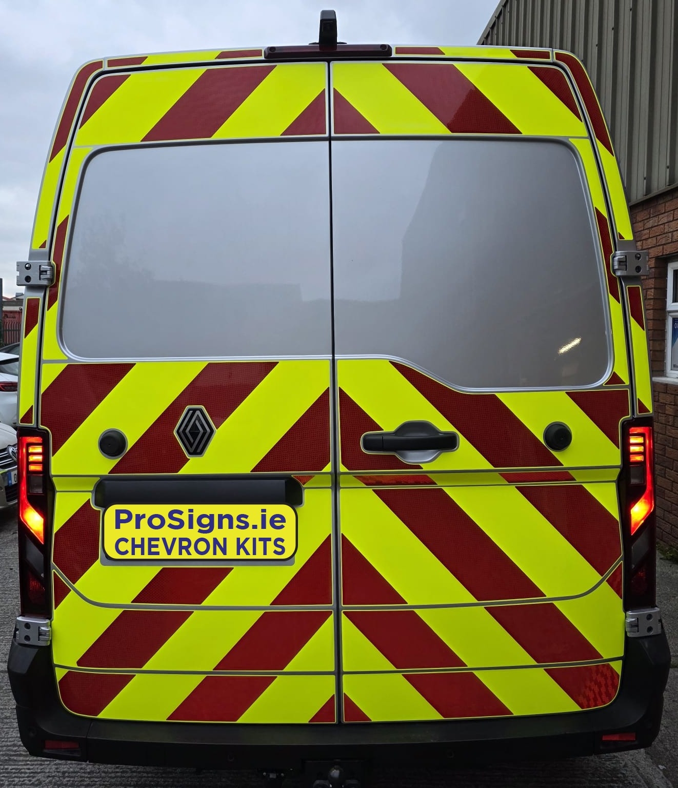 Rear view of a 2024 Renault Master van fitted with a full Chapter 8 compliant red and yellow reflective chevron kit by ProSigns.ie.